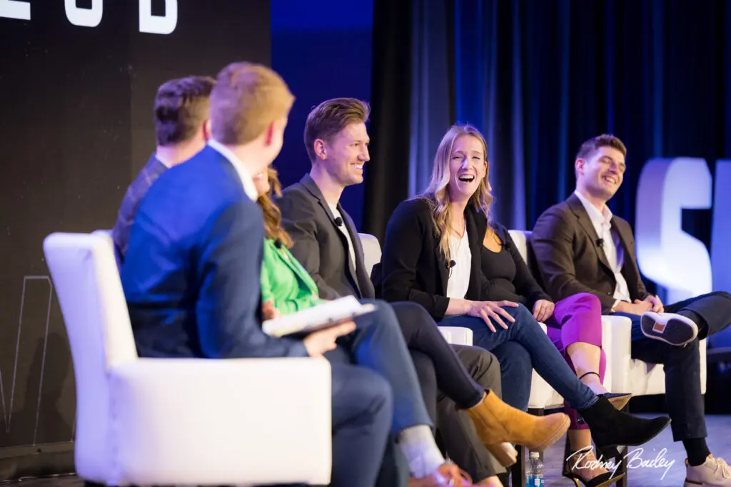 A group of people sitting on stage talking.