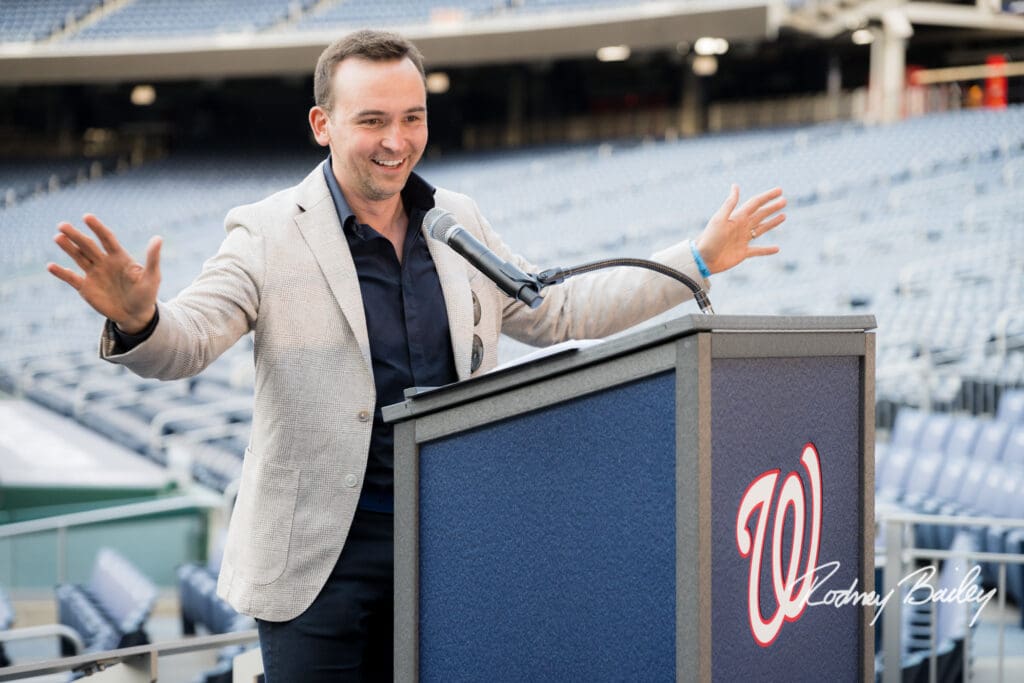 A man standing at a podium with a microphone.