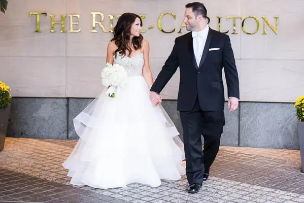 A bride and groom walking down the street