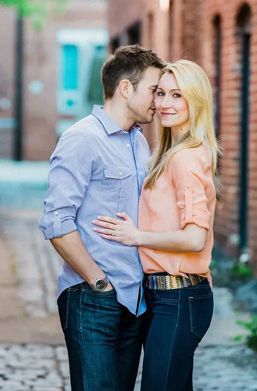 A man and woman kissing in the street.