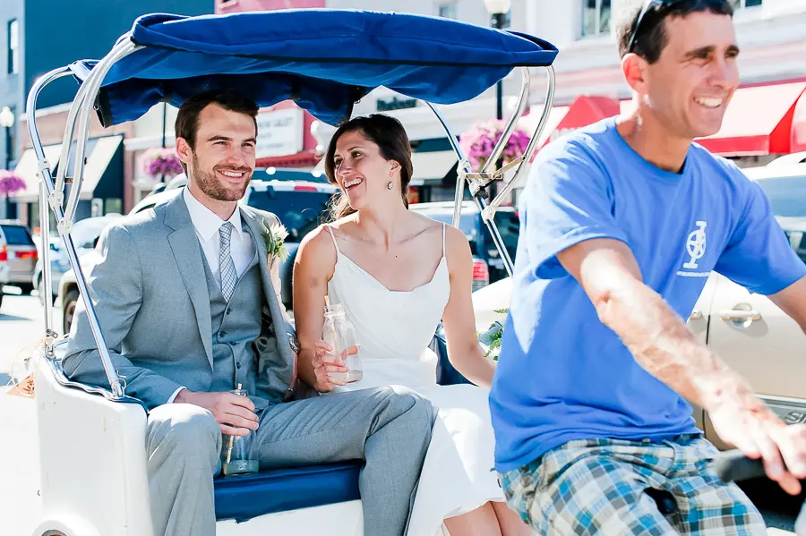 A man and woman sitting on the back of a boat.