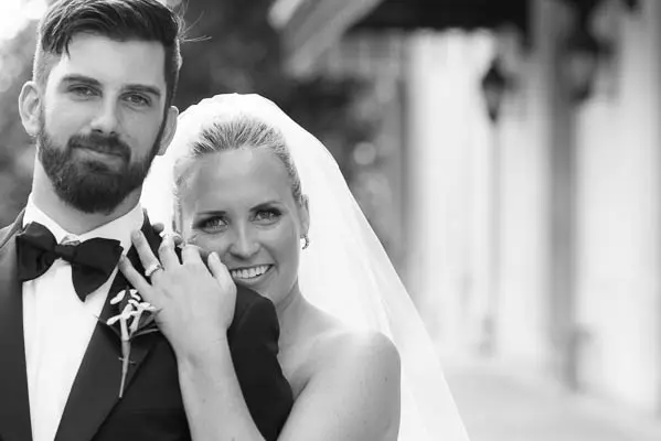 A bride and groom posing for a picture.