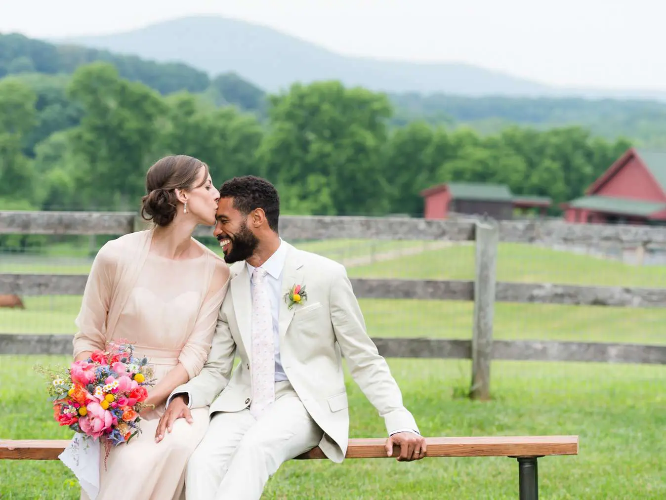 A man and woman kissing on the bench