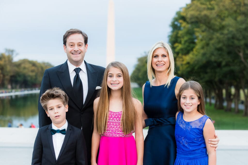 A family posing for a picture in formal wear.