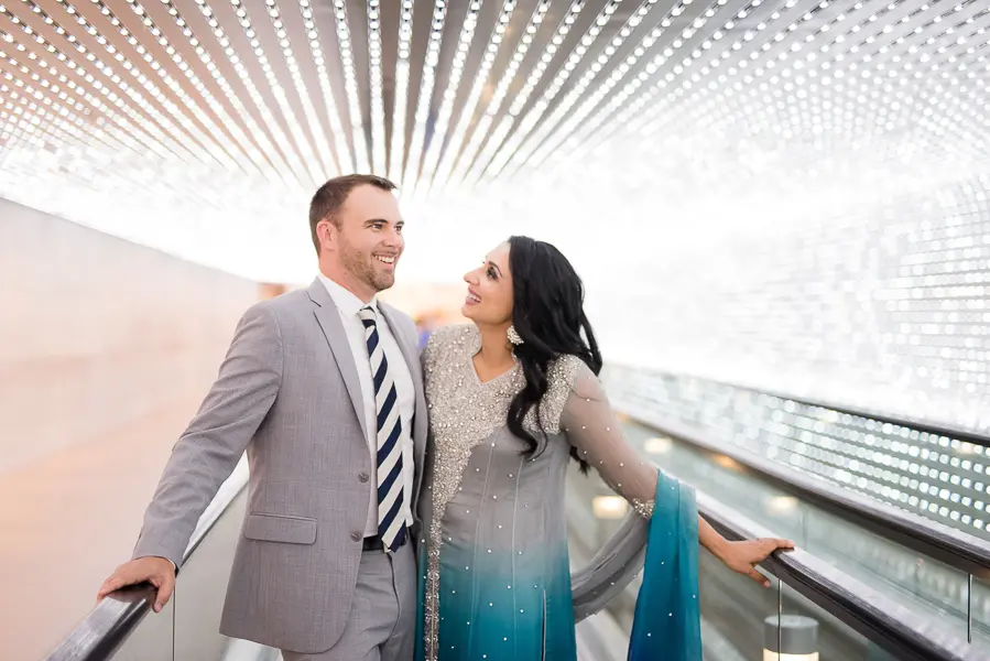 A man and woman standing on the stairs of an airport.