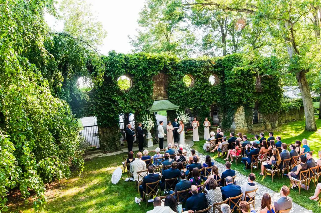 A group of people sitting in chairs on the grass.