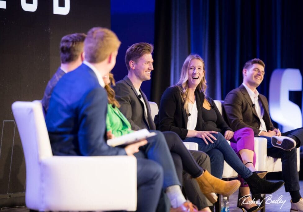 A group of people sitting on stage talking.