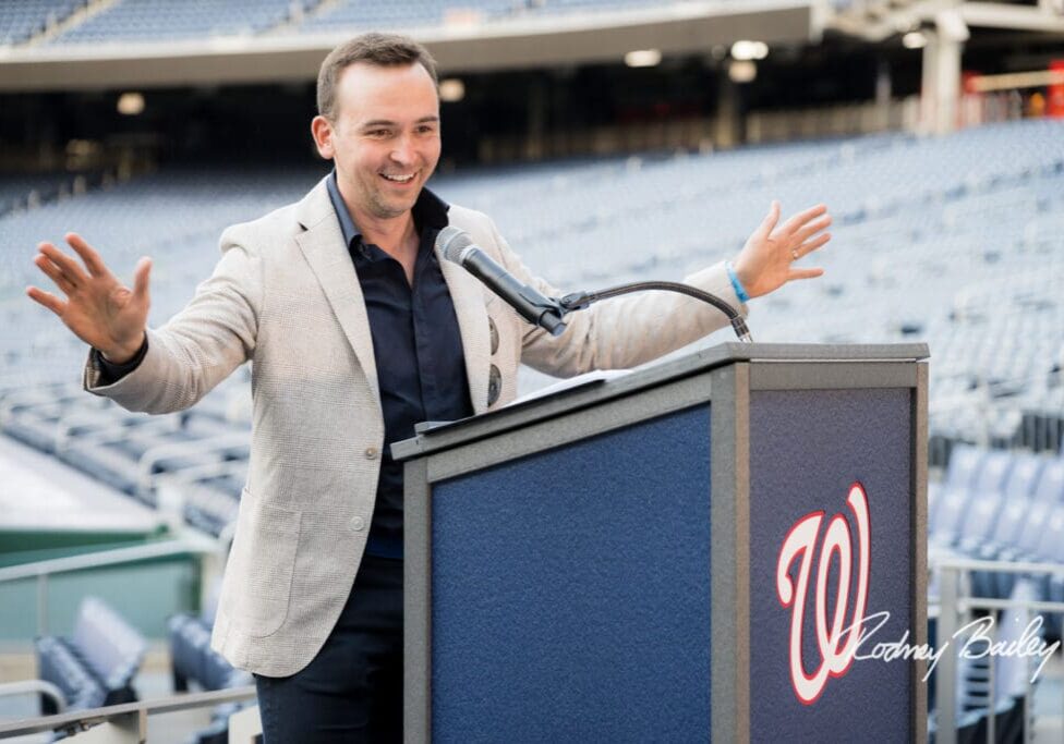 A man standing at a podium with a microphone.