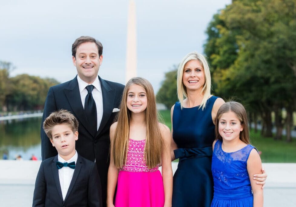 A family posing for a picture in formal wear.